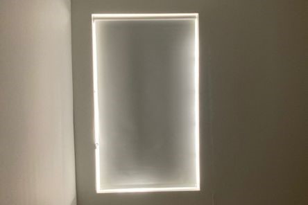 Custom blackout roller shades block all light in Palo Alto bedroom window for privacy and sleep comfort